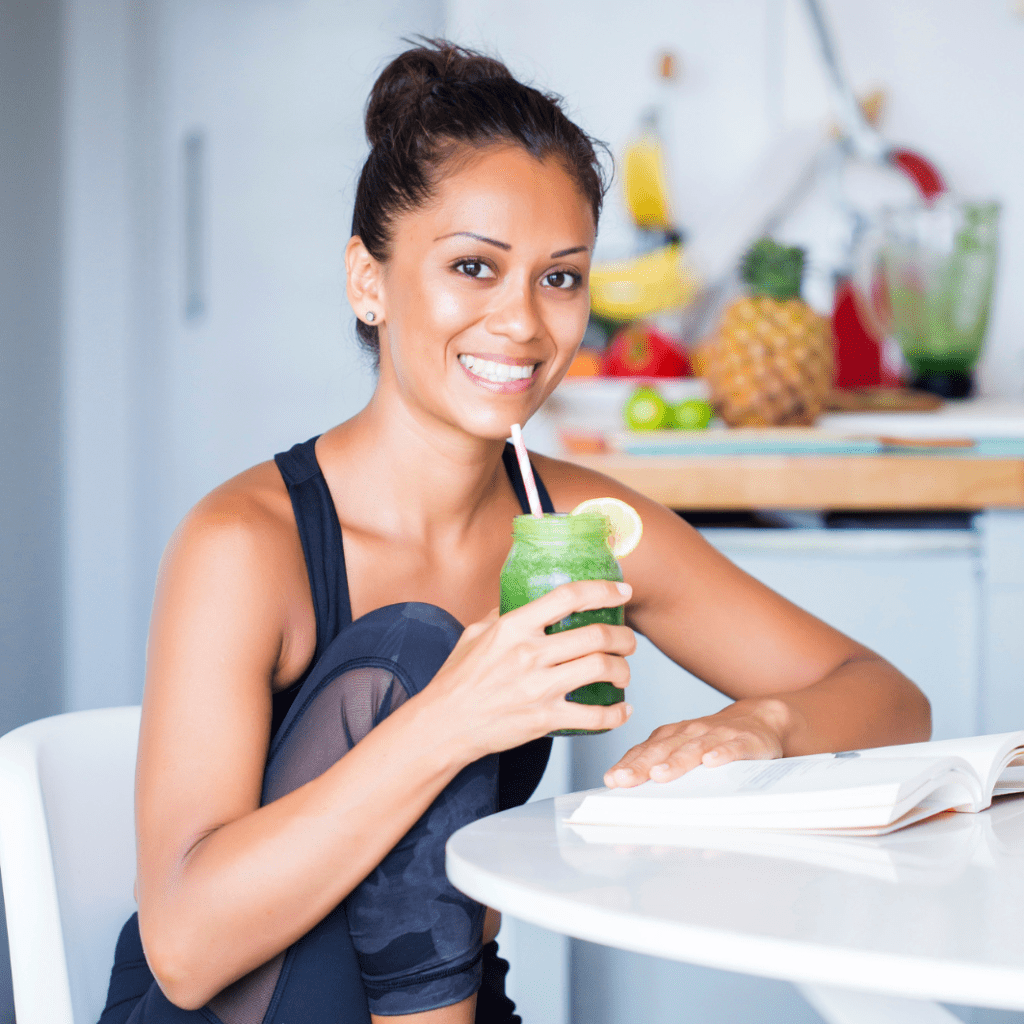 Happy woman holding up smoothie