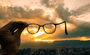 Looking through glasses held up to the sky