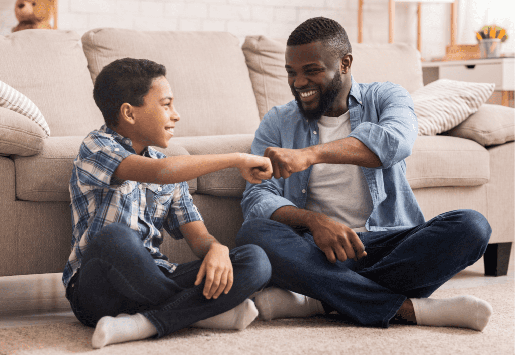 Dad and son fist bumping